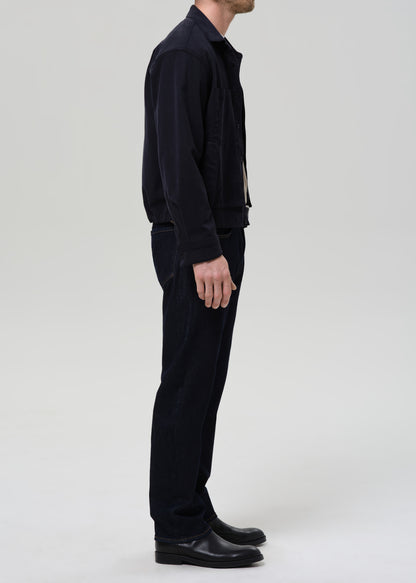 Person wearing a black outfit on a grey background