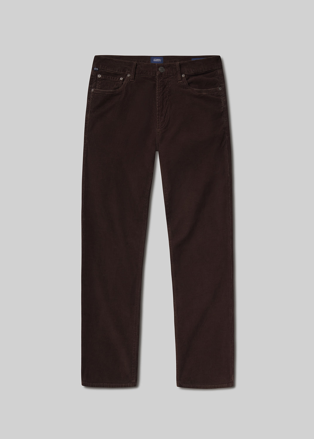 Flat lay of brown jeans on a grey background
