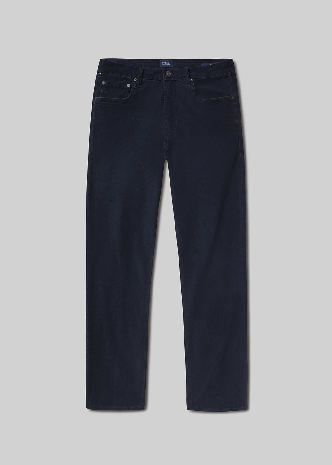 Flat lay shot of navy blue jeans on a grey background