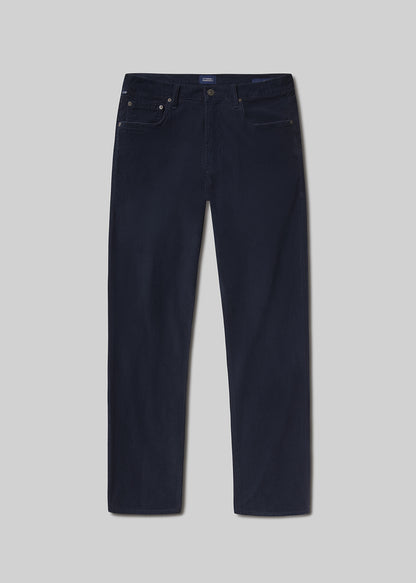 Flat lay shot of navy blue jeans on a grey background
