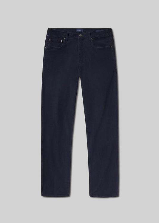 Flat lay shot of navy blue jeans on a grey background