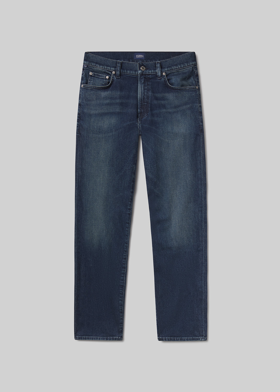 Flat lay of blue jeans on a grey background