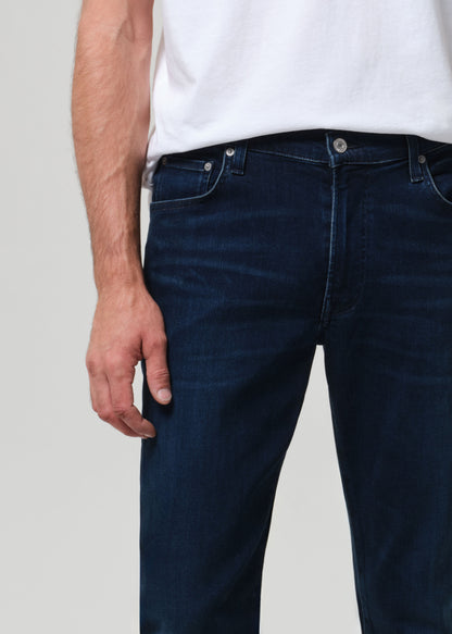 Person wearing a white t-shirt and dark jeans