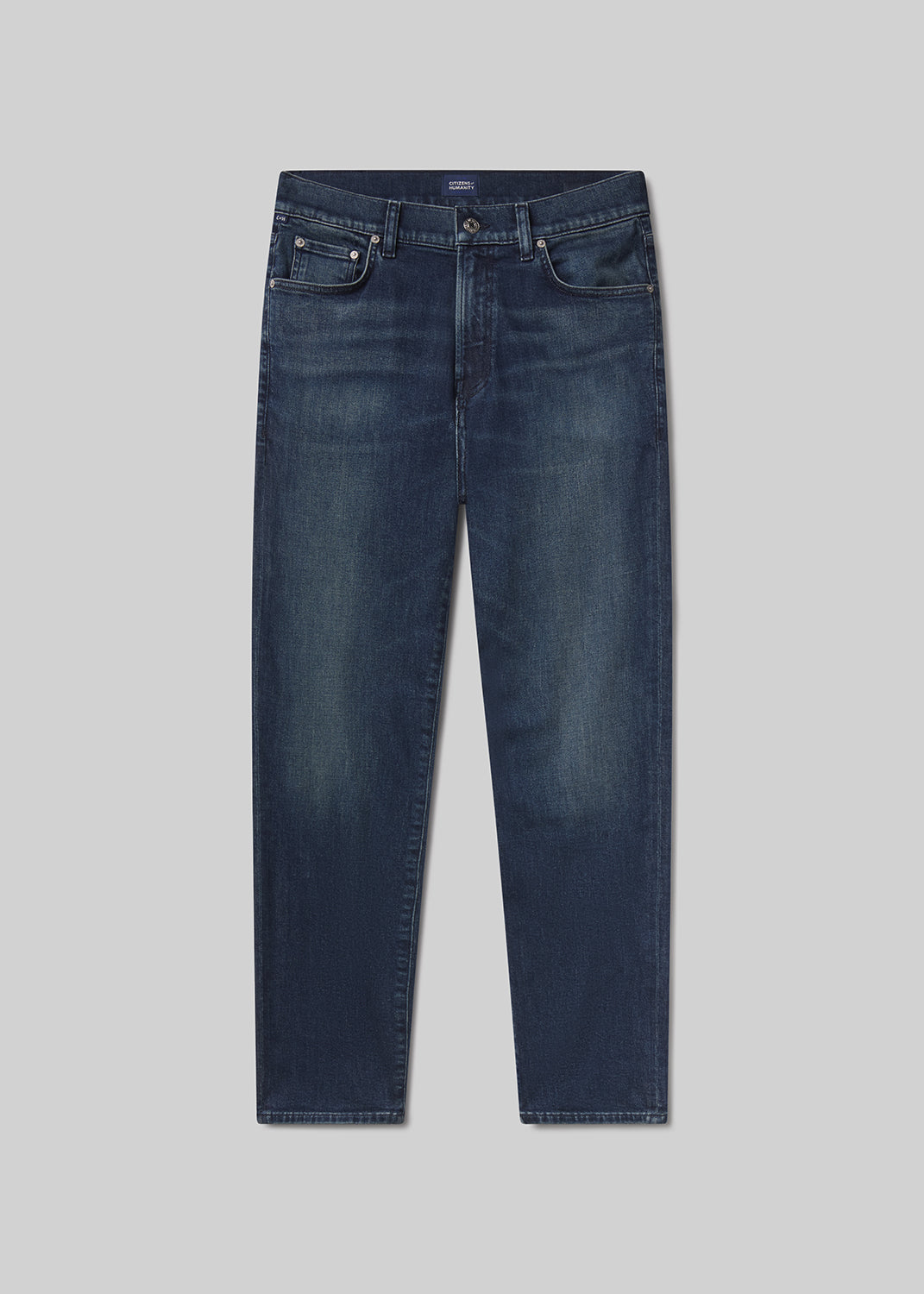 Flat shot of navy blue pants on a grey background