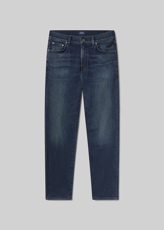 Flat shot of navy blue pants on a grey background