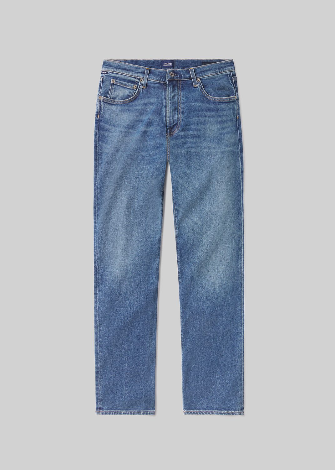 A pair of blue jeans on a grey background