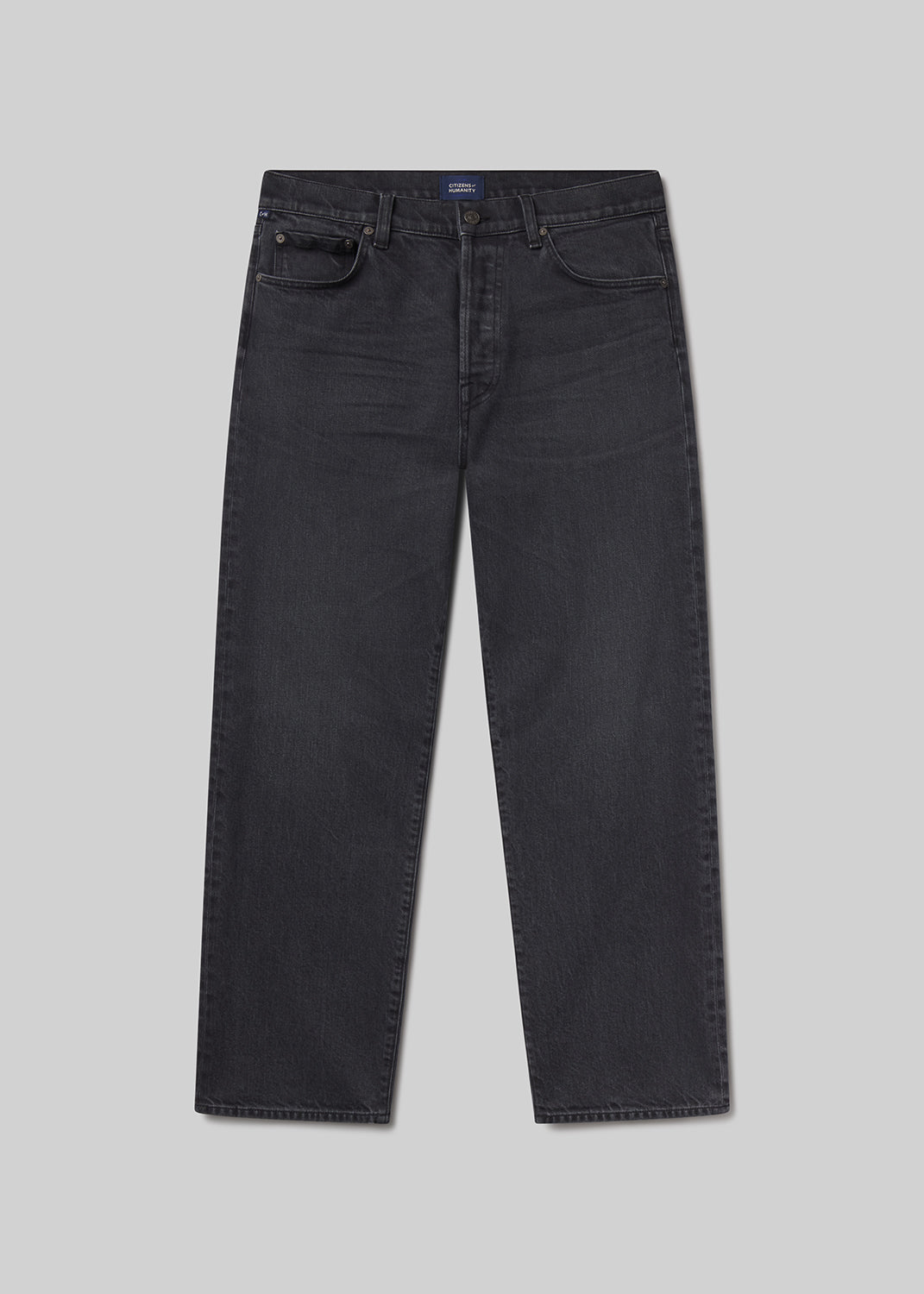Flat lay shot of black jeans on a grey background