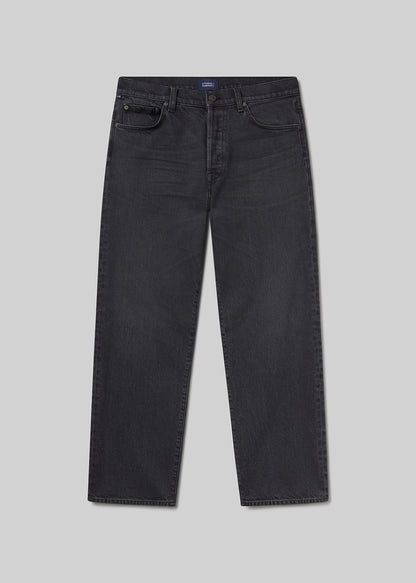 Flat lay shot of black jeans on a grey background