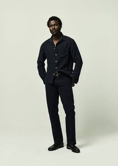Man wearing a navy shirt and pants on a plain background