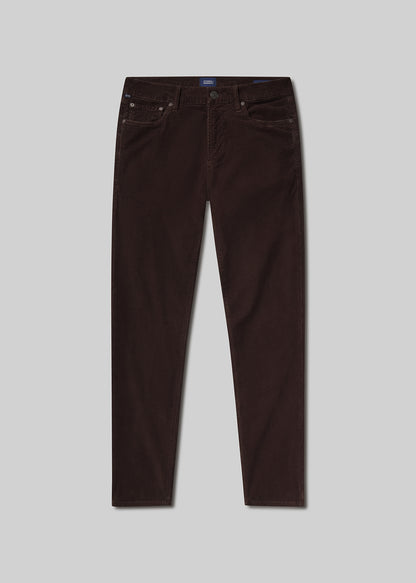 Flat lay of brown jeans on a light grey background