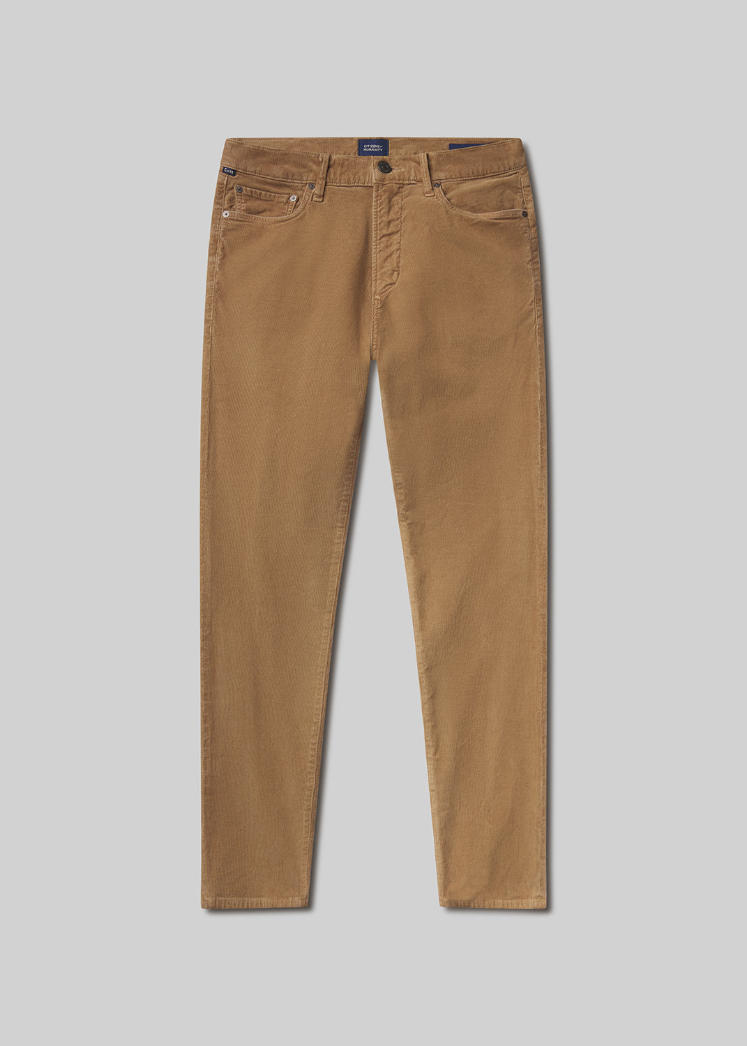 Flat lay shot of tan pants on a gray background
