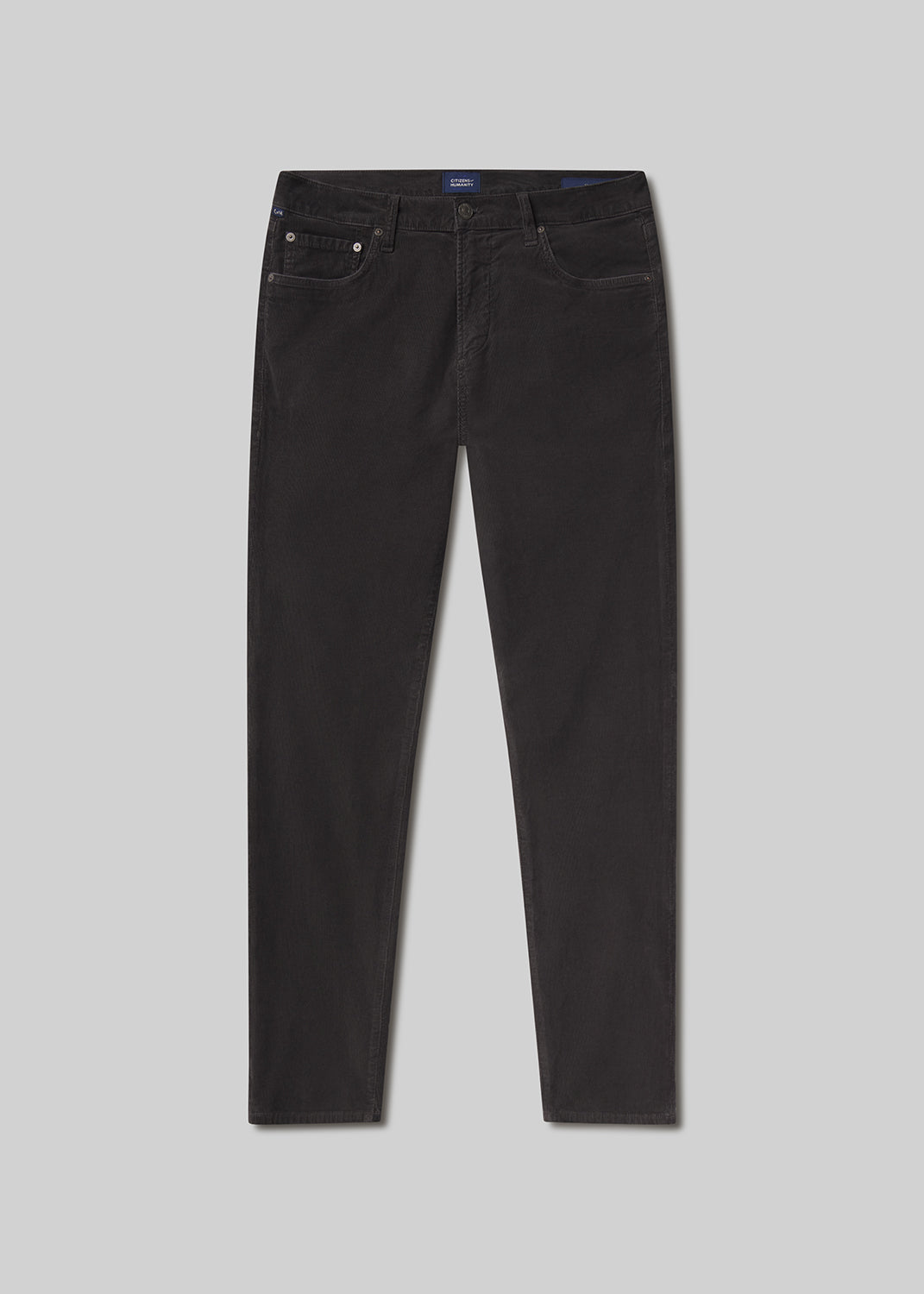 Flat lay shot of dark grey jeans on a grey background