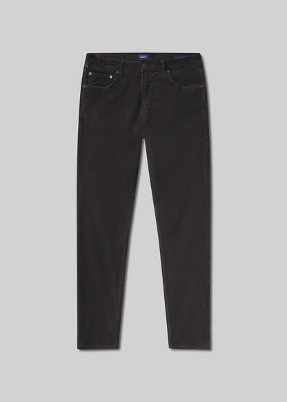 Flat lay shot of dark grey jeans on a grey background