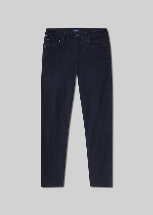 Flat lay shot of navy blue jeans on a light grey background