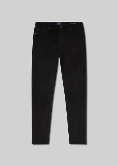 Flat lay shot of black jeans on a grey background