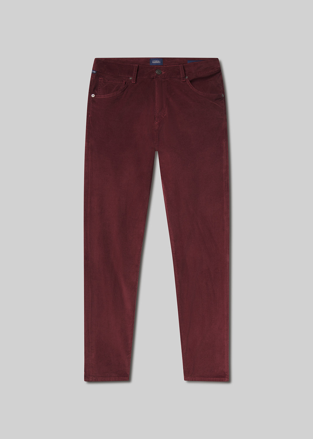 Flat lay shot of maroon pants on a grey background
