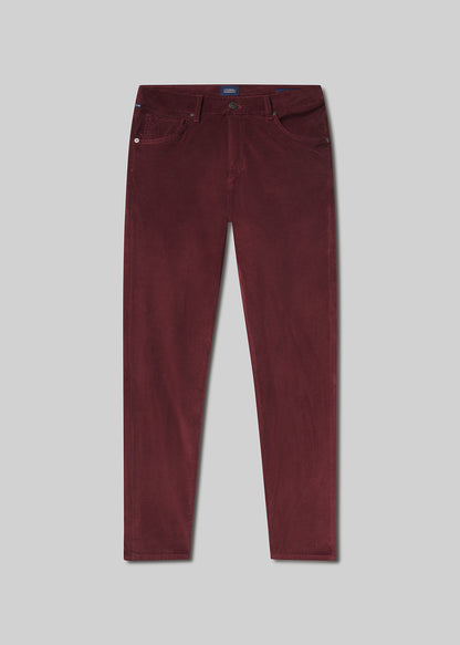 Flat lay shot of maroon pants on a grey background