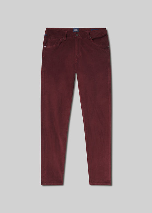 Flat lay shot of maroon pants on a grey background