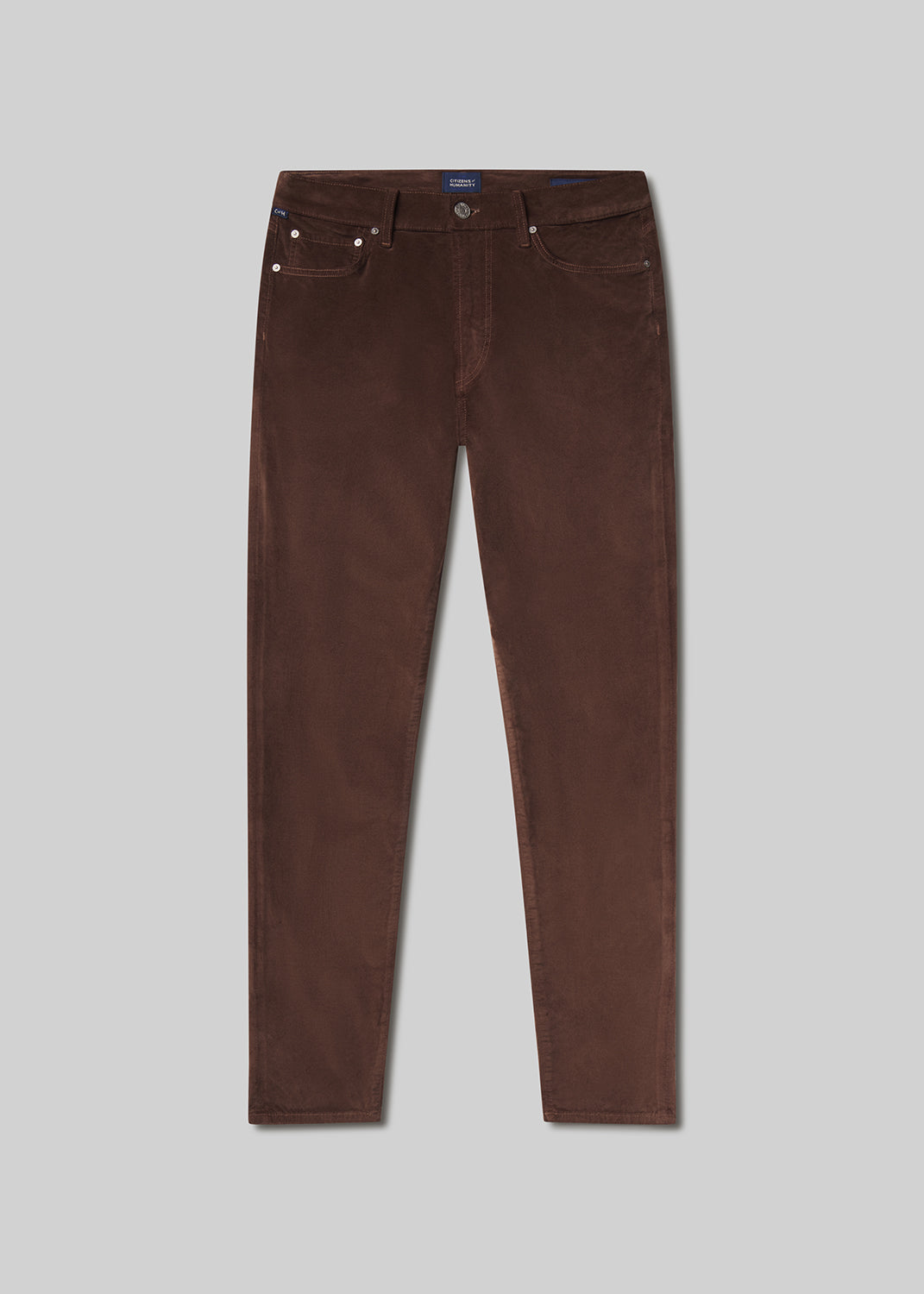 Flat lay of brown pants on a grey background