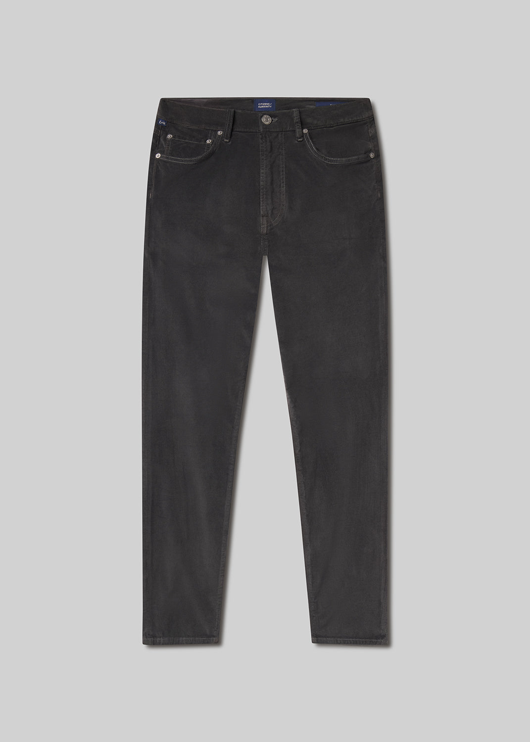 Flat lay of black jeans on a grey background