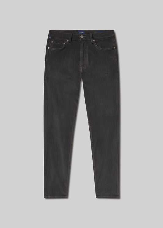Flat lay of black jeans on a grey background