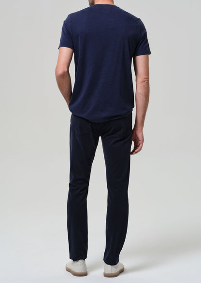 Person wearing a navy blue t-shirt and pants on a white background