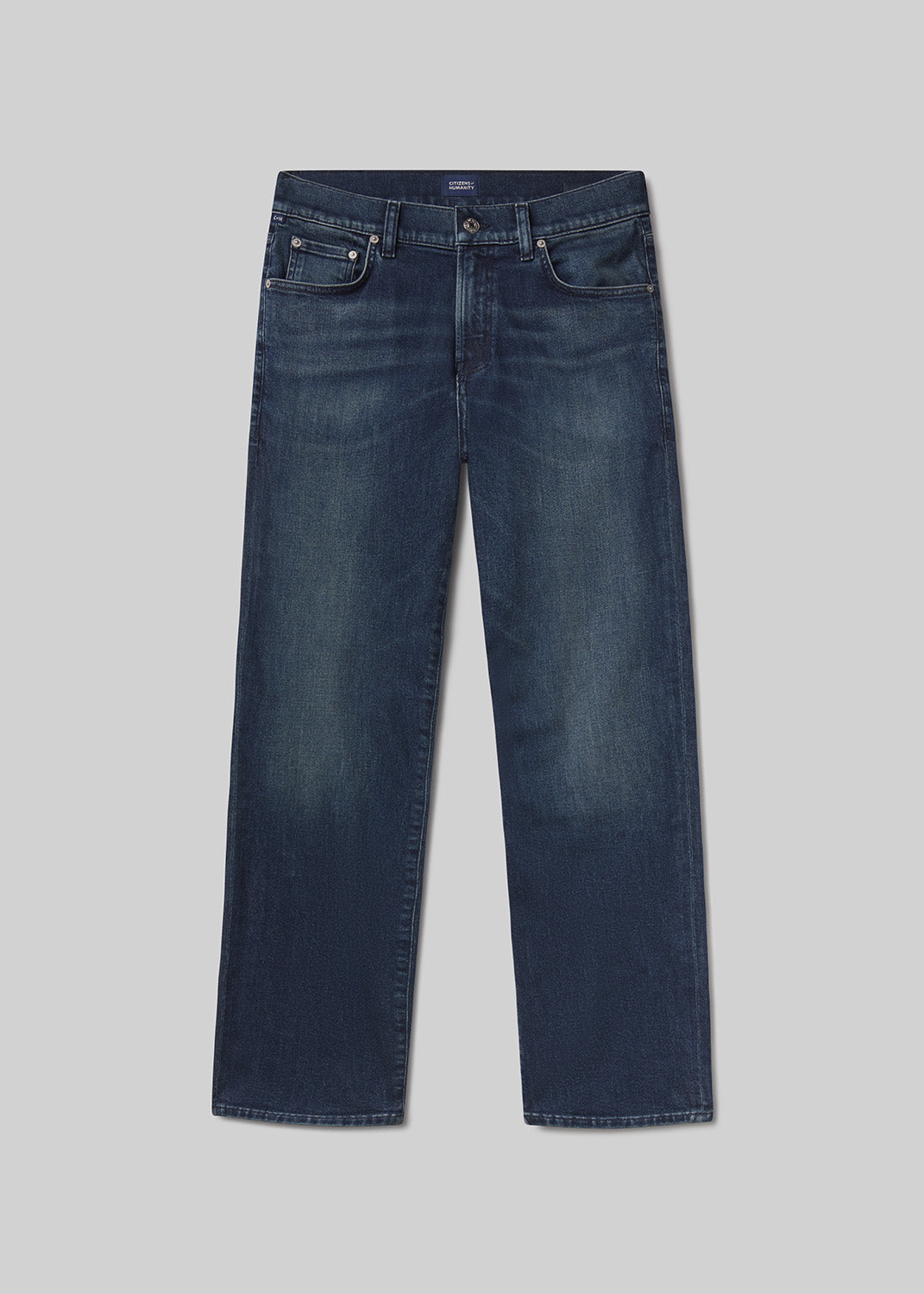 Flat lay of a pair of blue jeans on a grey background