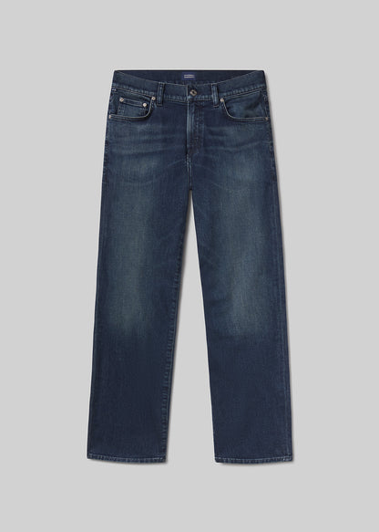 Flat lay of a pair of blue jeans on a grey background