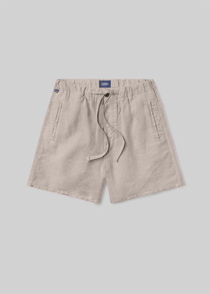 Beige drawstring shorts with an elastic waistband, adjustable drawstring, and side pockets, front flat lay view on a grey background.
