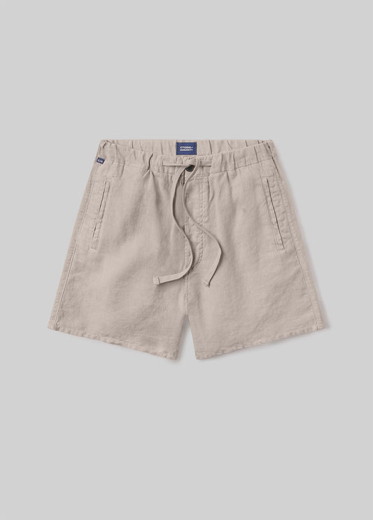 Beige drawstring shorts with an elastic waistband, adjustable drawstring, and side pockets, front flat lay view on a grey background.