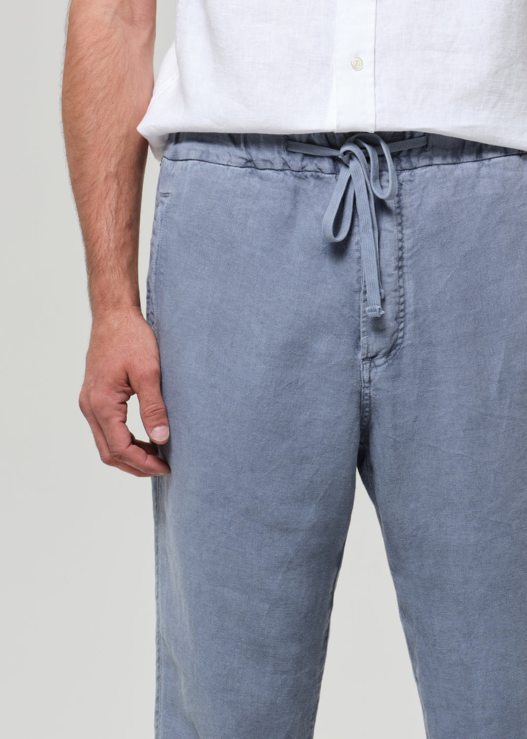 Light blue pants with a drawstring waist worn by a person on a plain background