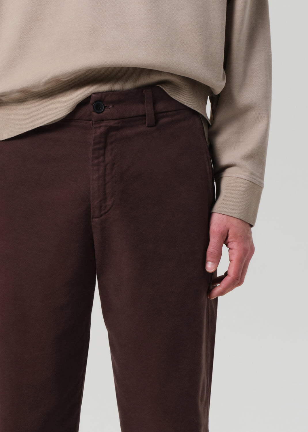 Brown pants worn by a person against a plain background