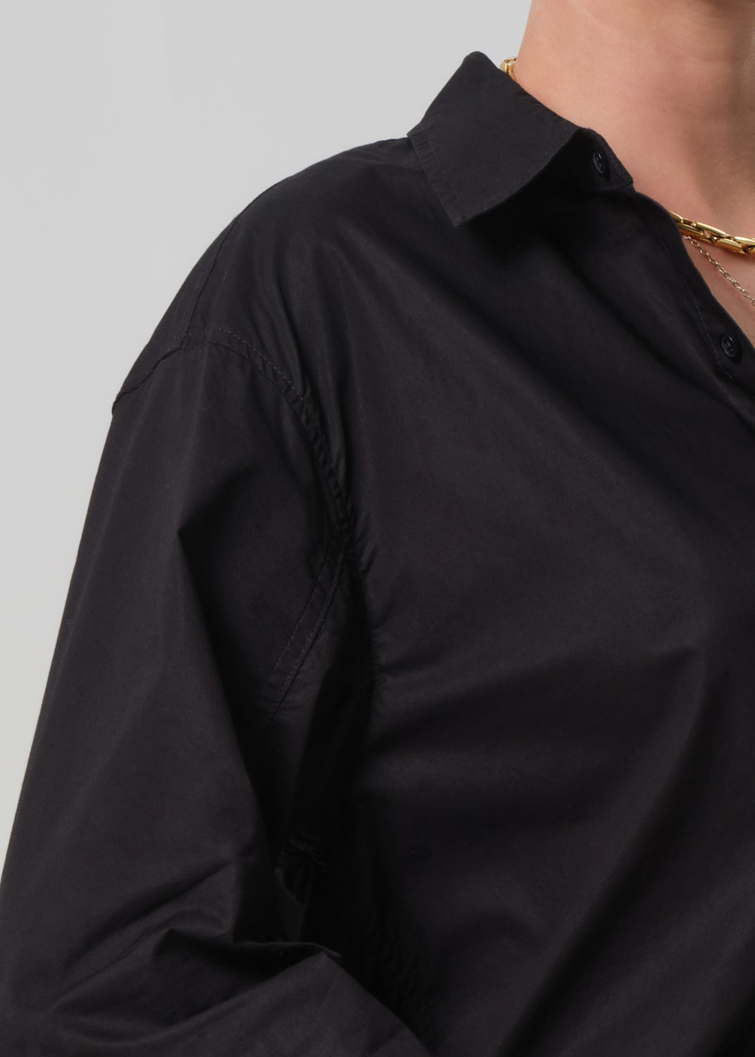 Person wearing a black oversized shirt 