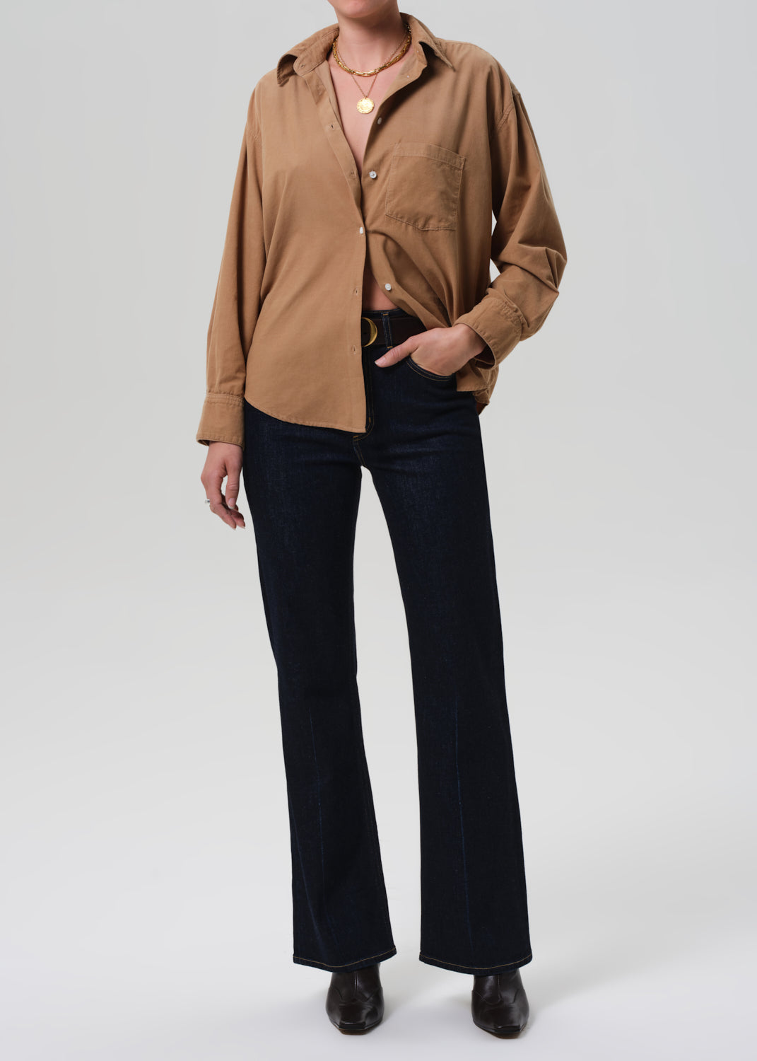 Brown corduroy shirt worn by a person on a grey background
