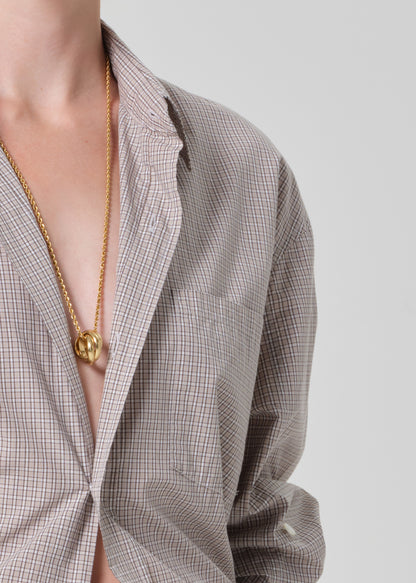 Person wearing a light brown plaid shirt 