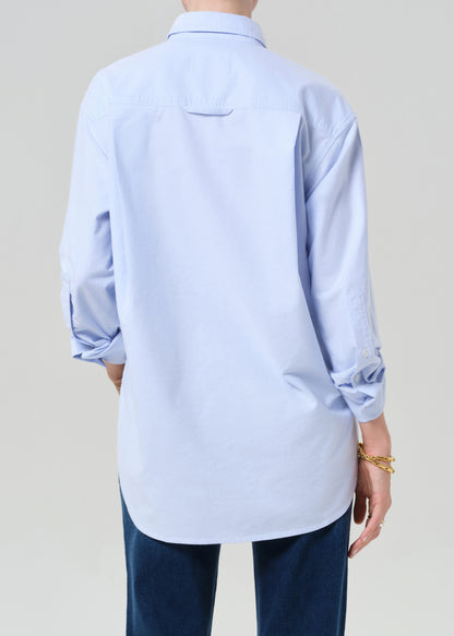 Light blue shirt worn by a person on a plain background