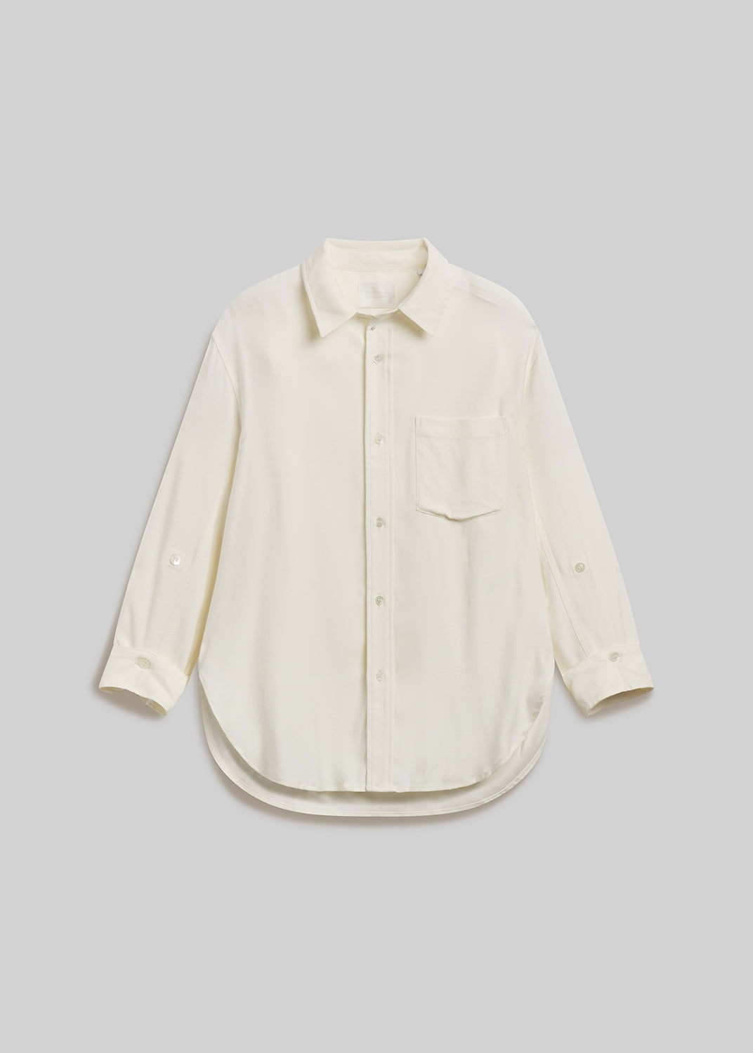 Ivory long-sleeve button-down shirt with chest pocket on grey background