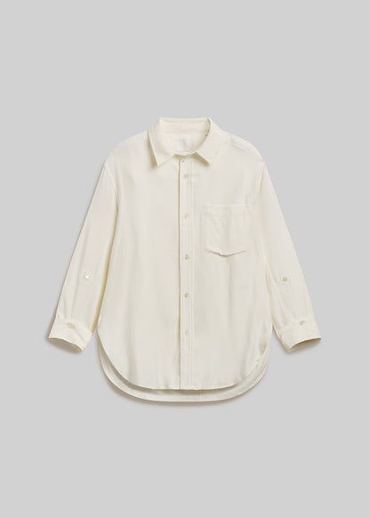 Ivory long-sleeve button-down shirt with chest pocket on grey background