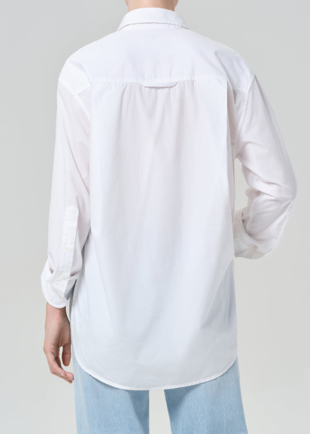 White shirt worn by a person on a plain background