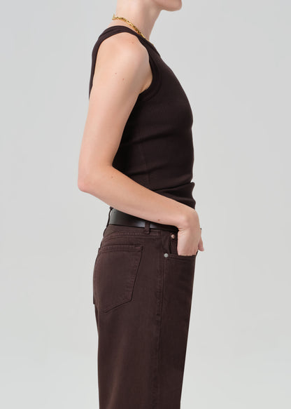Person wearing a brown ribbed tank top with brown pants