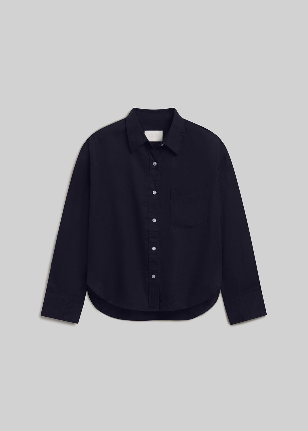 True navy long-sleeve linen button-down shirt with a pointed collar, front button closure, single chest pocket, buttoned cuffs, and curved hem, front flat lay view on a grey background.