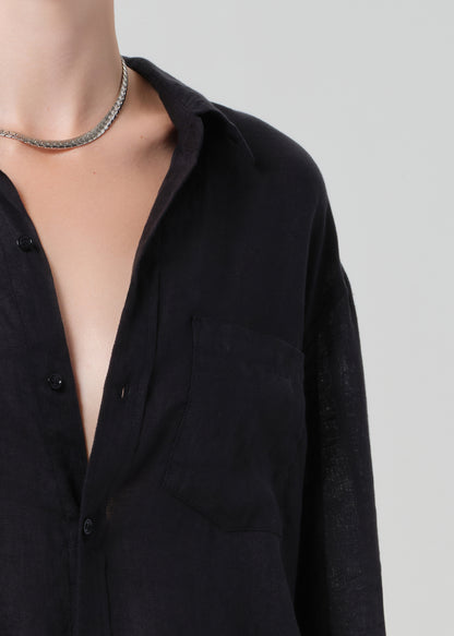 Black shirt with a deep neckline on a plain background