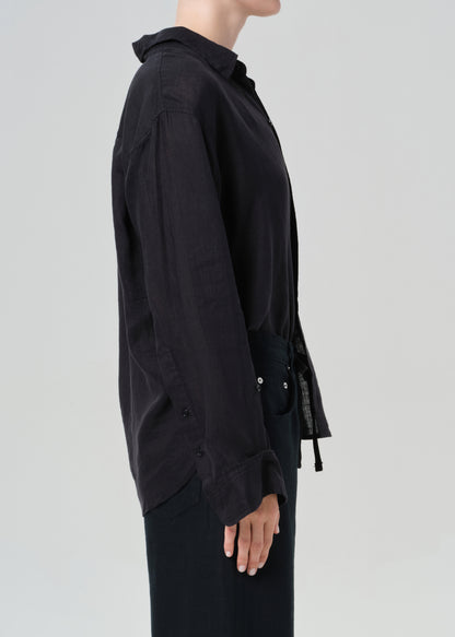 Black shirt worn by a person on a light gray background