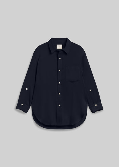 Navy long sleeve button-down shirt with chest pocket on grey background