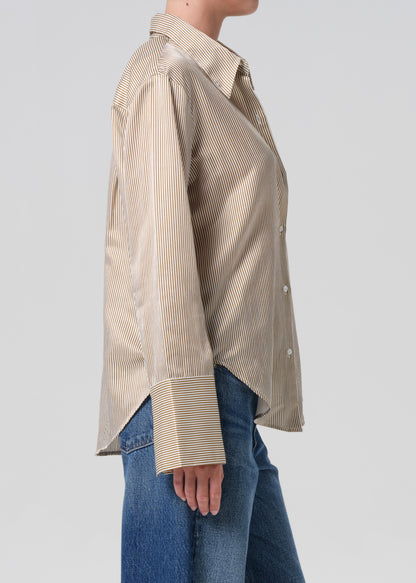 Beige striped shirt worn by a person on a plain background