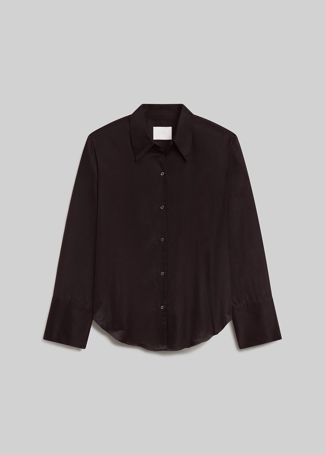 Brown long-sleeve button-down shirt with a pointed collar, front button closure, wide cuffs, and curved hem, front flat lay view on a grey background.