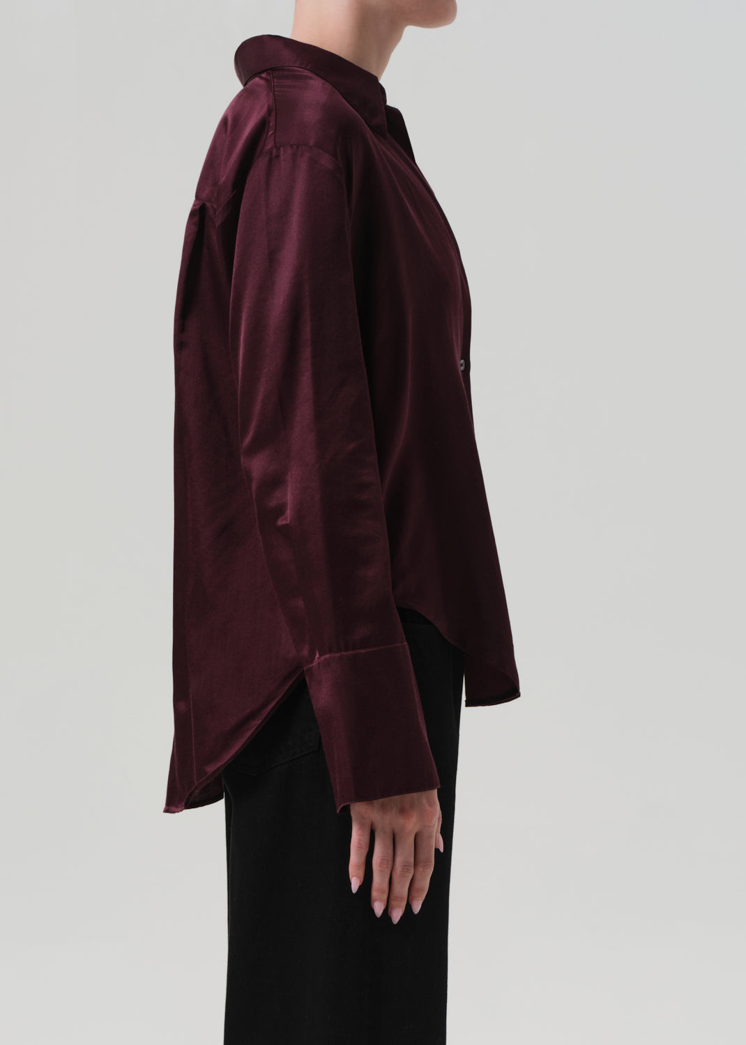 Burgundy shirt worn by a person on a plain background