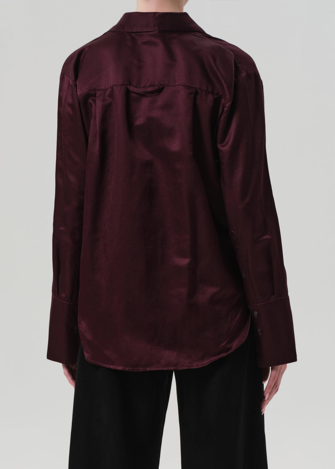 Burgundy shirt worn by a person on a plain background
