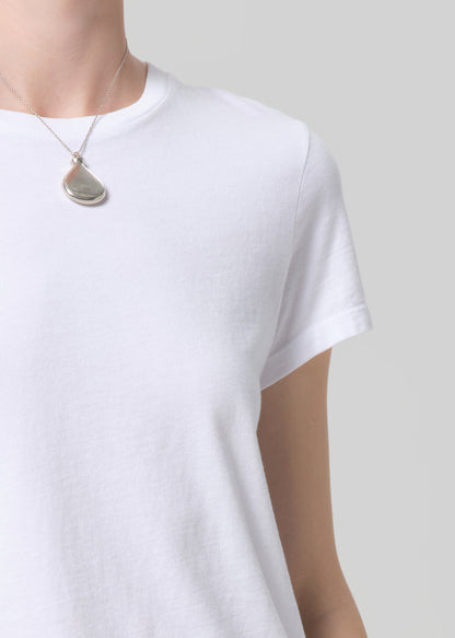 White t-shirt worn by a person on a plain background