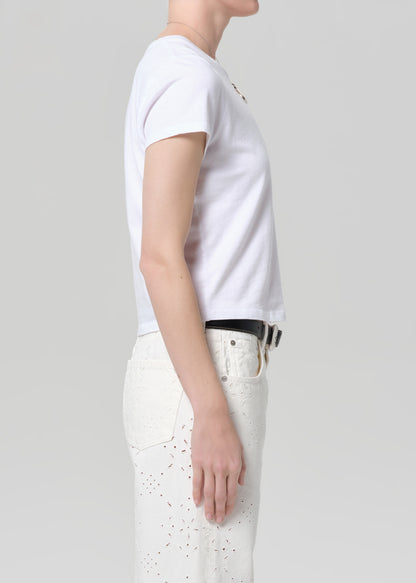 Person wearing a white t-shirt and pants on a plain background